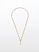 Long adjustable T chain with a centered rough pearl pendant. 24K yellow gold plated.