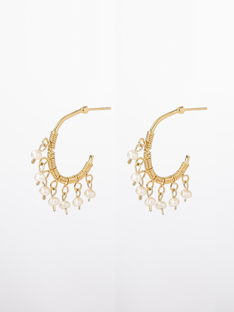 Thea earrings- Delicate hoop earrings with seven dangling tiny pearls.
The earrings are of 24K yellow gold plated. hoop diameter: 2cm.